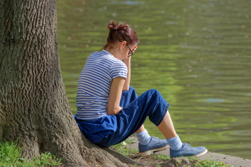 Girl relaxing on lakeshore